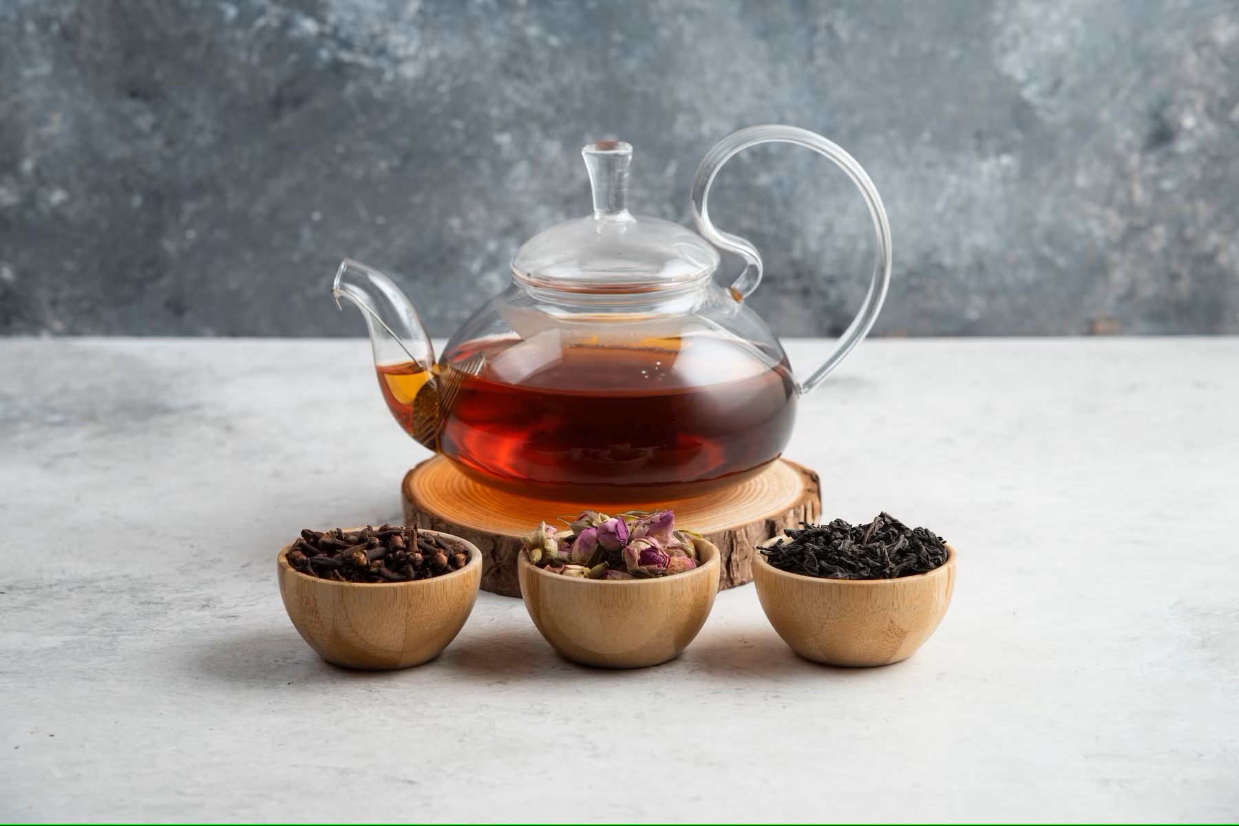 a-glass-teapot-with-wooden-bowls-of-loose-teas_114579-38595.jpg