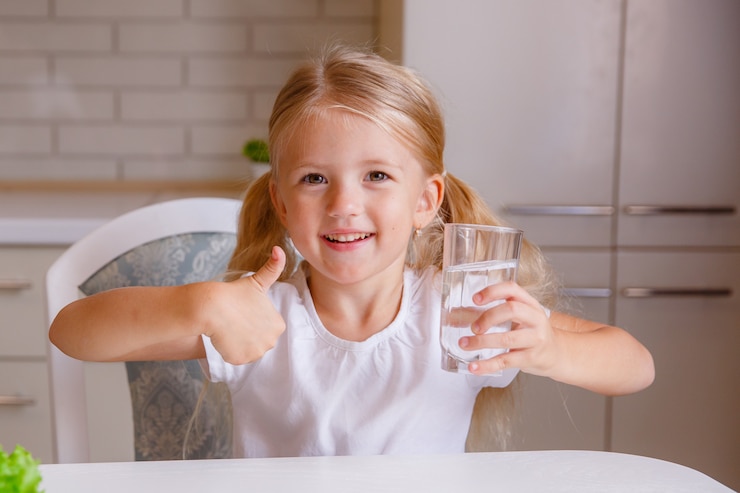 girl-showing-thumbs-up-sign-and-holding-a-transparent-glass-child-recommend-drinking-water-good-healthy-habit-for-children-healthcare-concept_106368-214.jpg