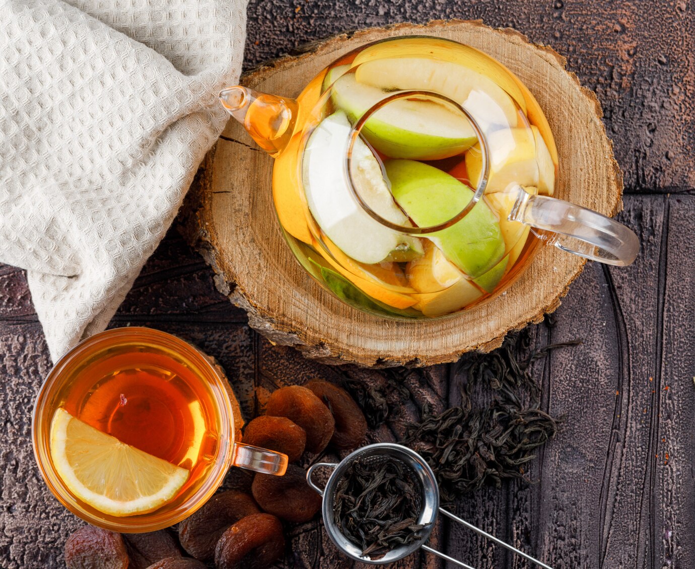 fruit-infused-water-teapot-with-tea-dried-apricots-wood-kitchen-towel-container-flat-lay-stone-tile-surface_176474-6361.jpg