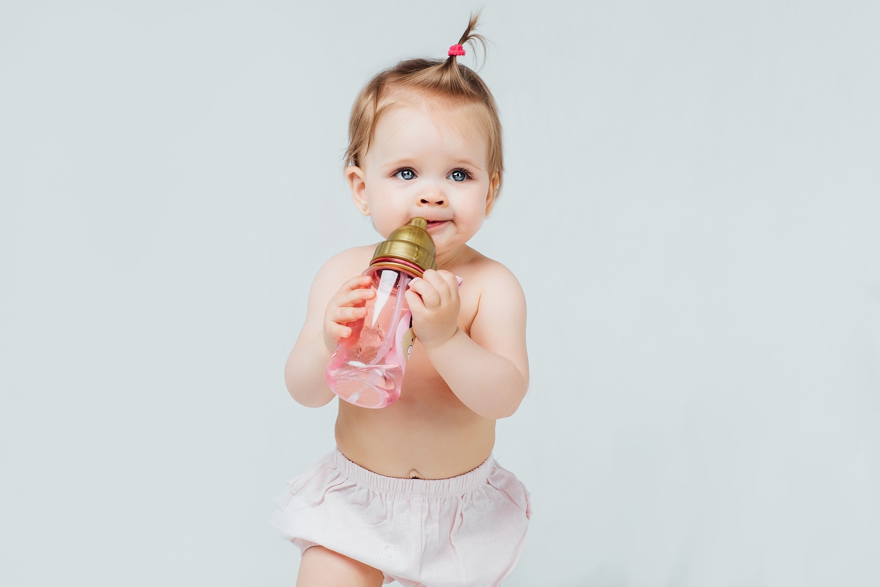 happy-girl-diaper-with-cute-hairstyle-holds-bottle-milk_496169-799 (1).jpg