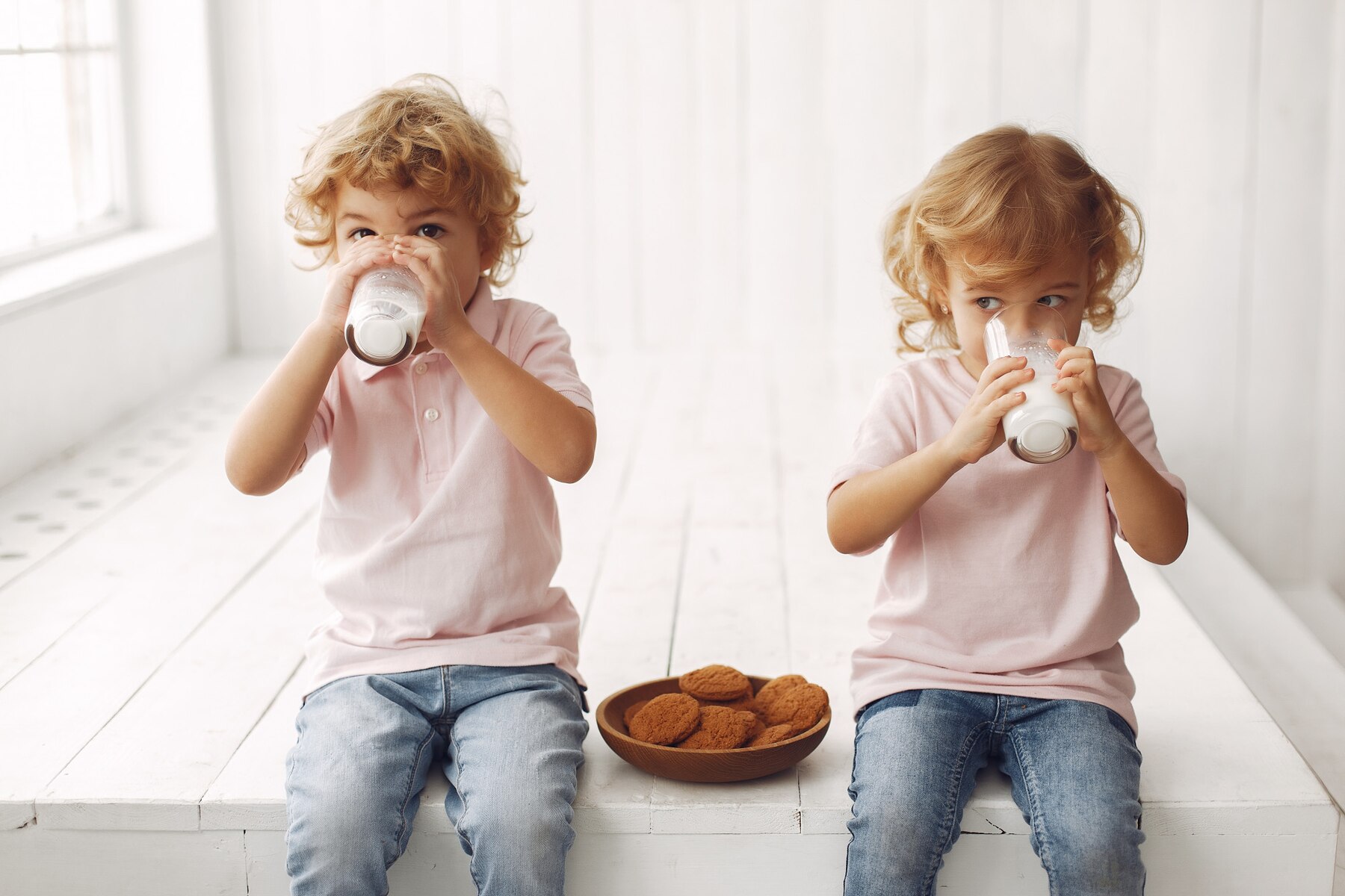 cute-children-eating-cookies-and-drinking-milk_1157-32468.jpg