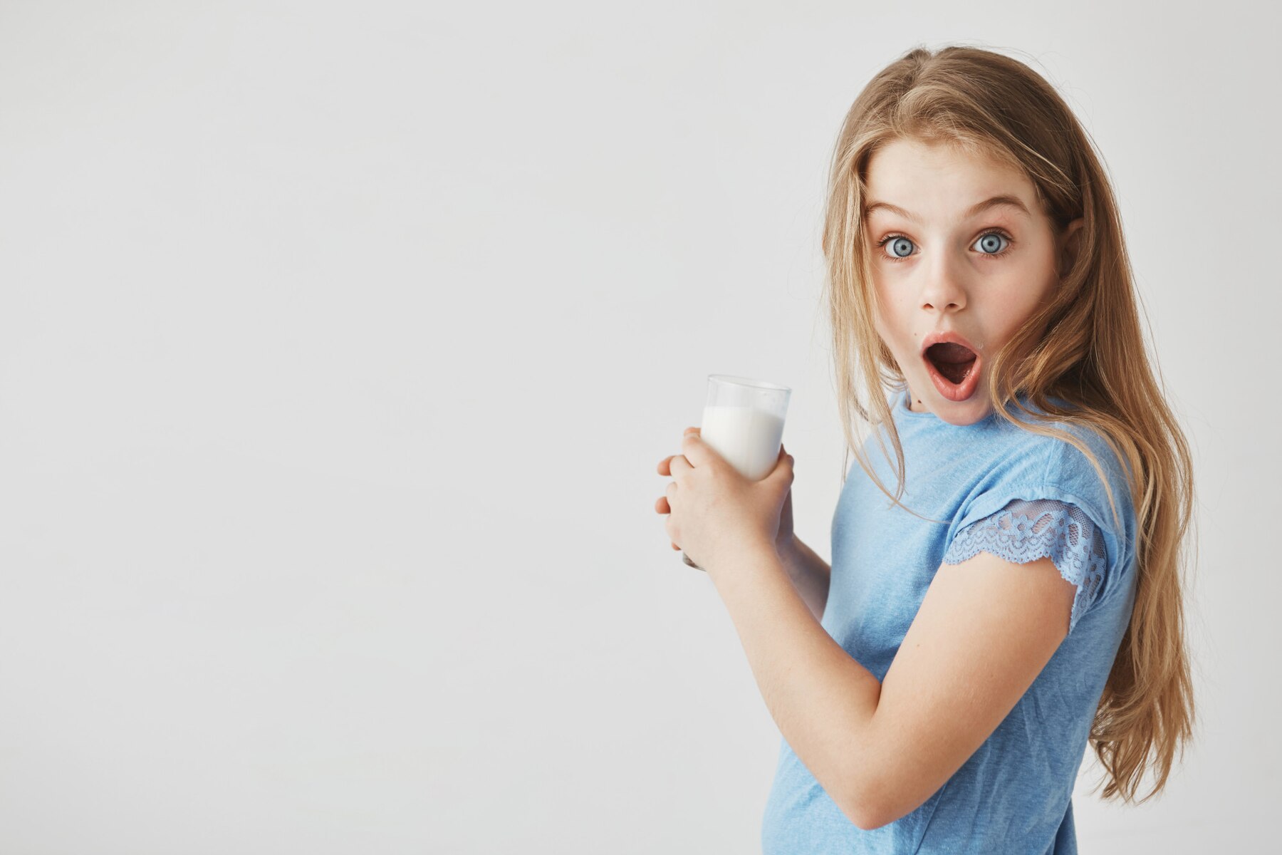 close-up-portrait-of-funny-good-looking-little-girl-with-light-hair-with-shocked-expression-holding-glass-of-milk-with-hands_176420-10227.jpg